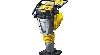 Bomag BT65 Vibrationsstampfer in Gelb-Schwarz mit gefaltetem Federbalg und schwarzer Verdichtungsplatte.